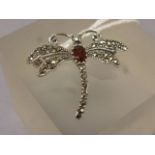 A silver marcasite and garnet dragonfly brooch