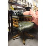 A vintage green leather Captains swivel chair