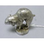 A vintage chrome car mascot in the form of a manx cat
