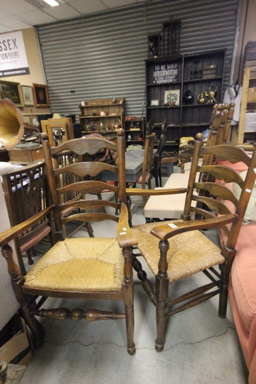 Two Oak Ladder Back Elbow Chairs with String Seats