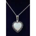 Silver heart shaped opal pendant surrounded by sapphires