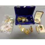 A collection of costume jewellery including brooches, along with a set of weighing scales