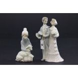 A Lladro figure of a wedding couple, along with a boy holding a lamp