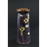 A large Watcombe ware pottery vase decorated with flowers