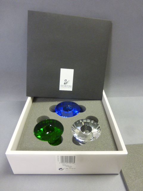 Three Swarovski candlesticks, boxed