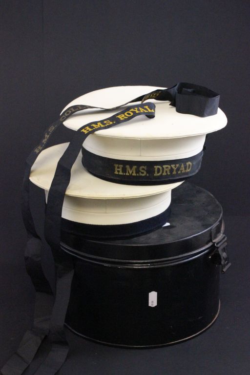 A naval hat tin, along with two hats