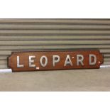 A wooden naval plaque with chrome lettering for H.M.S Leopard