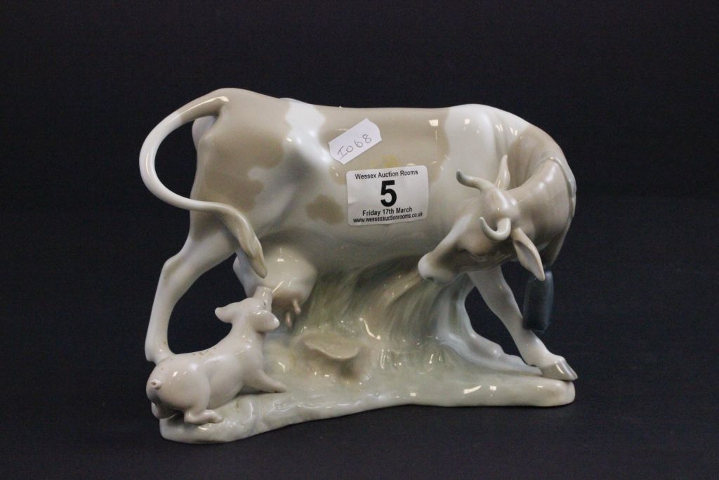 A Lladro figure of a cow and a pig