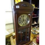 An oak cased wall clock