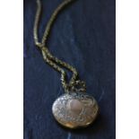 Small gold locket on yellow metal chain