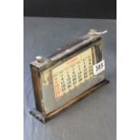 A silver case perpetual calendar, on a mahogany base, Birmingham 1929