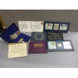 A small collection of coins sets, along with commemorative Concorde silver cased plaque