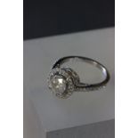 14ct White gold diamond ring in the halo style with central stone of 1.5ct approx