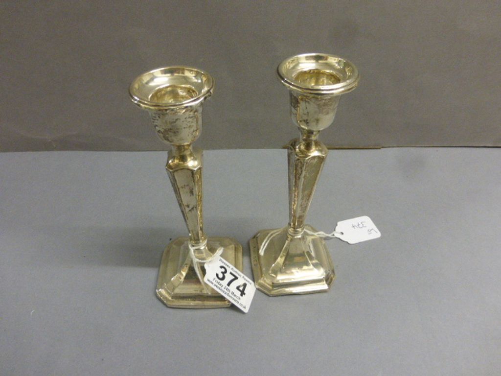 A pair of silver candlesticks, weighted, Birmingham 1920