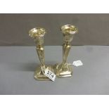 A pair of silver candlesticks, weighted, Birmingham 1920