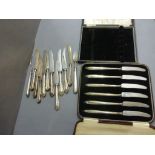 A cased set of knives, each with a silver handle 1939, along with various other silver handled