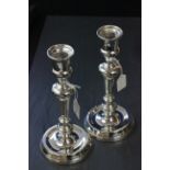 A pair of sliver candlesticks, with mahogany weighted bases, London 1913, 23cm high