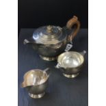 A three piece silver tea service, comprising teapot, sugar bowl and milk jug, London 1936