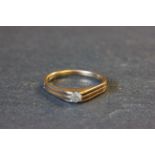 Yellow metal and solitaire diamond ring