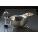 A silver sauce boat, with three hoof feet, Birmingham 1937