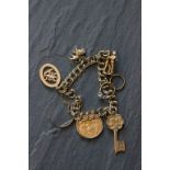 Vintage 9ct gold charm bracelet with charms to include a 22ct gold full Sovereign dated 1911