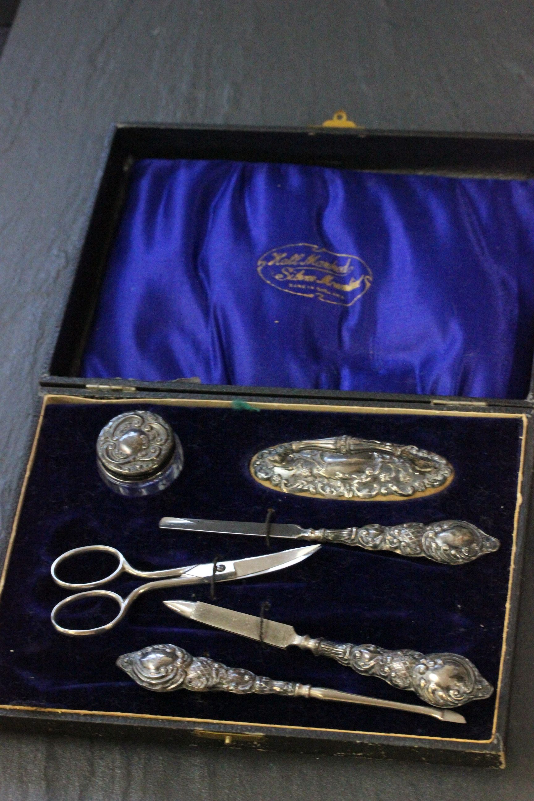 A cased silver mounted manicure set, Birmingham 1913, Gibson & Co