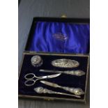 A cased silver mounted manicure set, Birmingham 1913, Gibson & Co