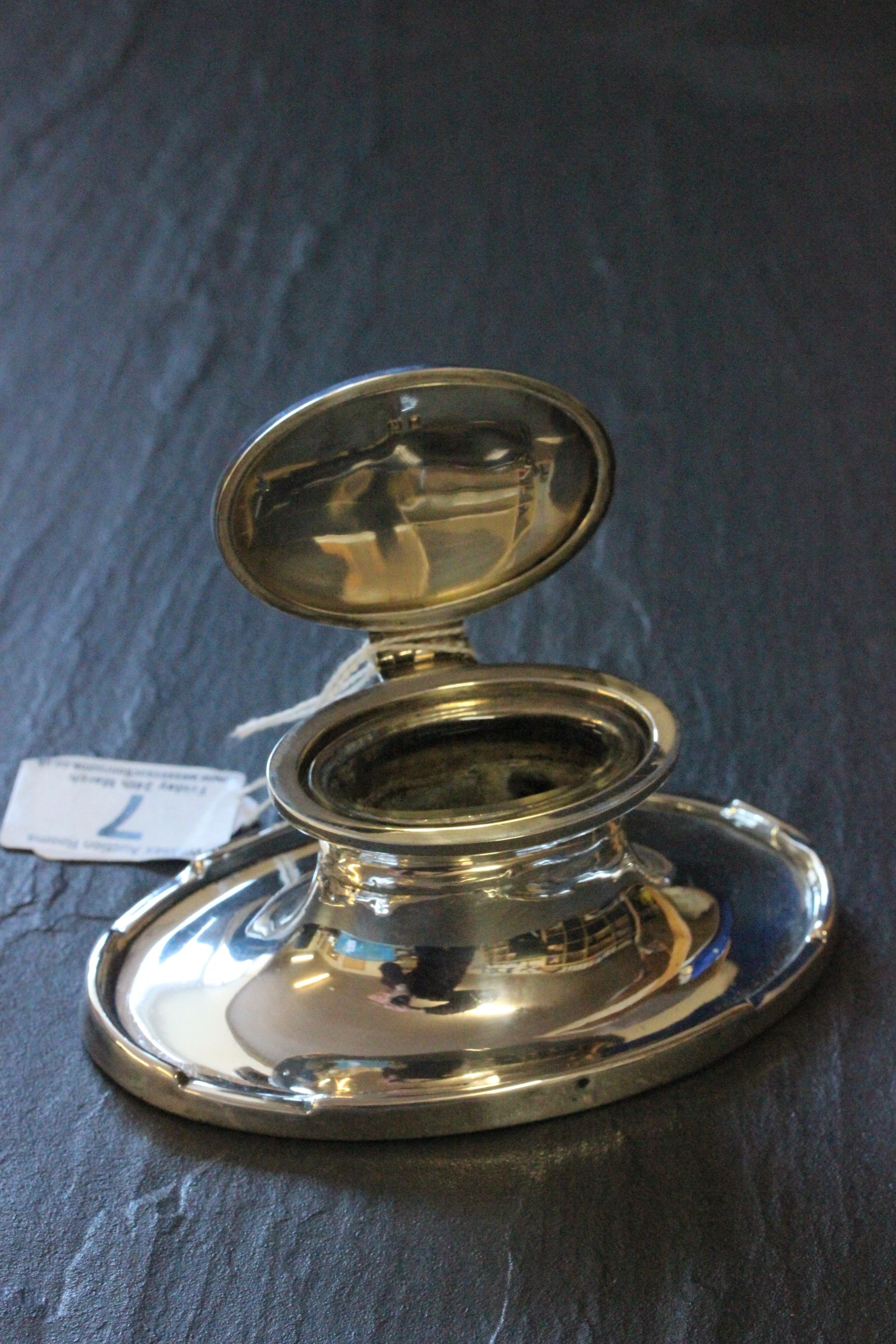 A 20th century oval silver capstan inkwell with glass insert, Birmingham, 1924, A & J Zimmerman