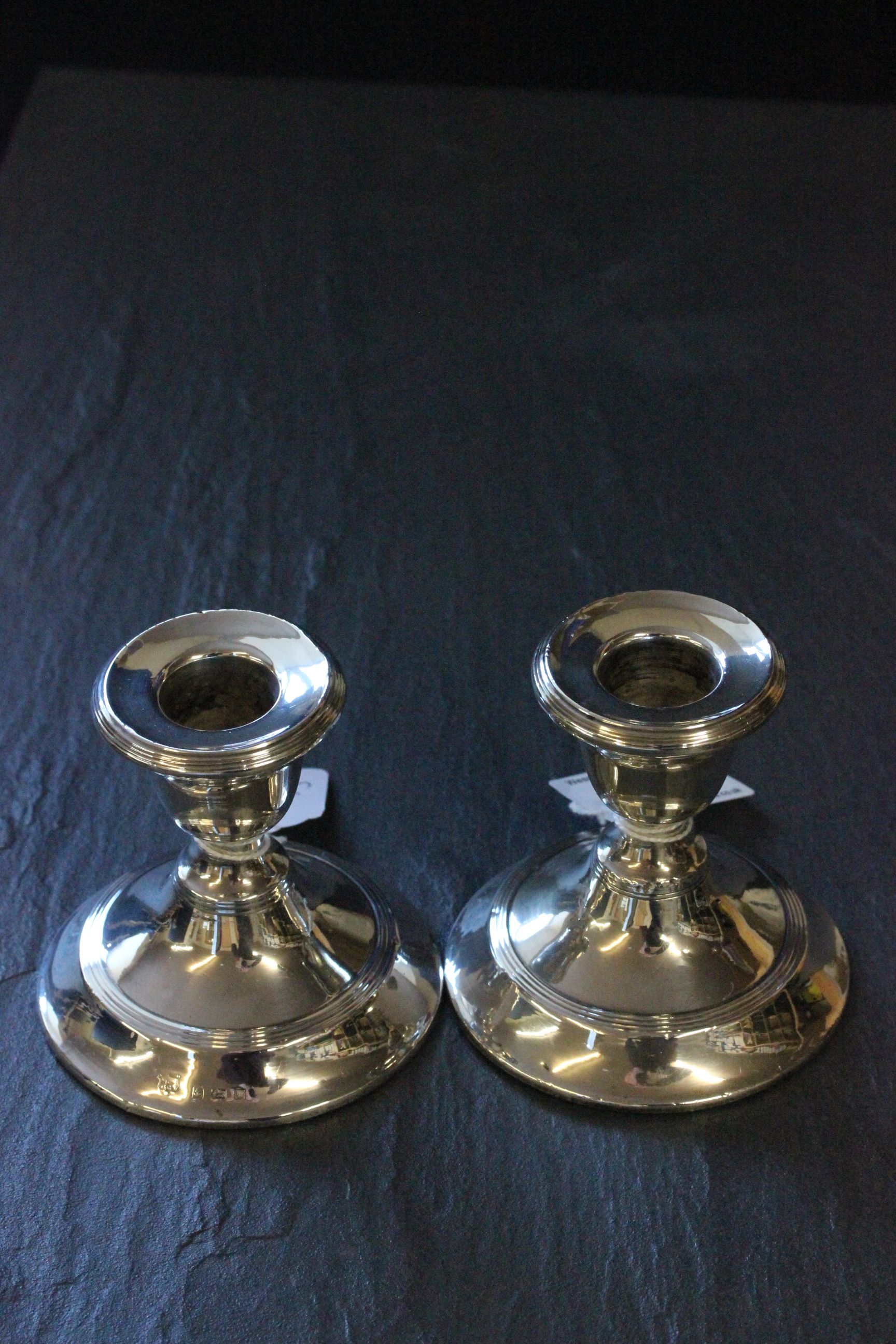 A pair of silver dwarf candlesticks weighted, Birmingham 1922