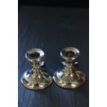 A pair of silver dwarf candlesticks weighted, Birmingham 1922
