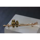 Boxed 15ct gold bar brooch depicting Owls on a branch with Emerald set eyes