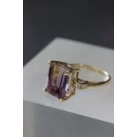 14ct Yellow gold ring the central stone of amethyst and citrine with baguette cut diamond