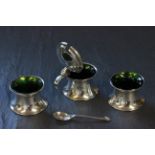 A three piece silver cruet set, with green glass liner and matching spoon, Birmingham 1910