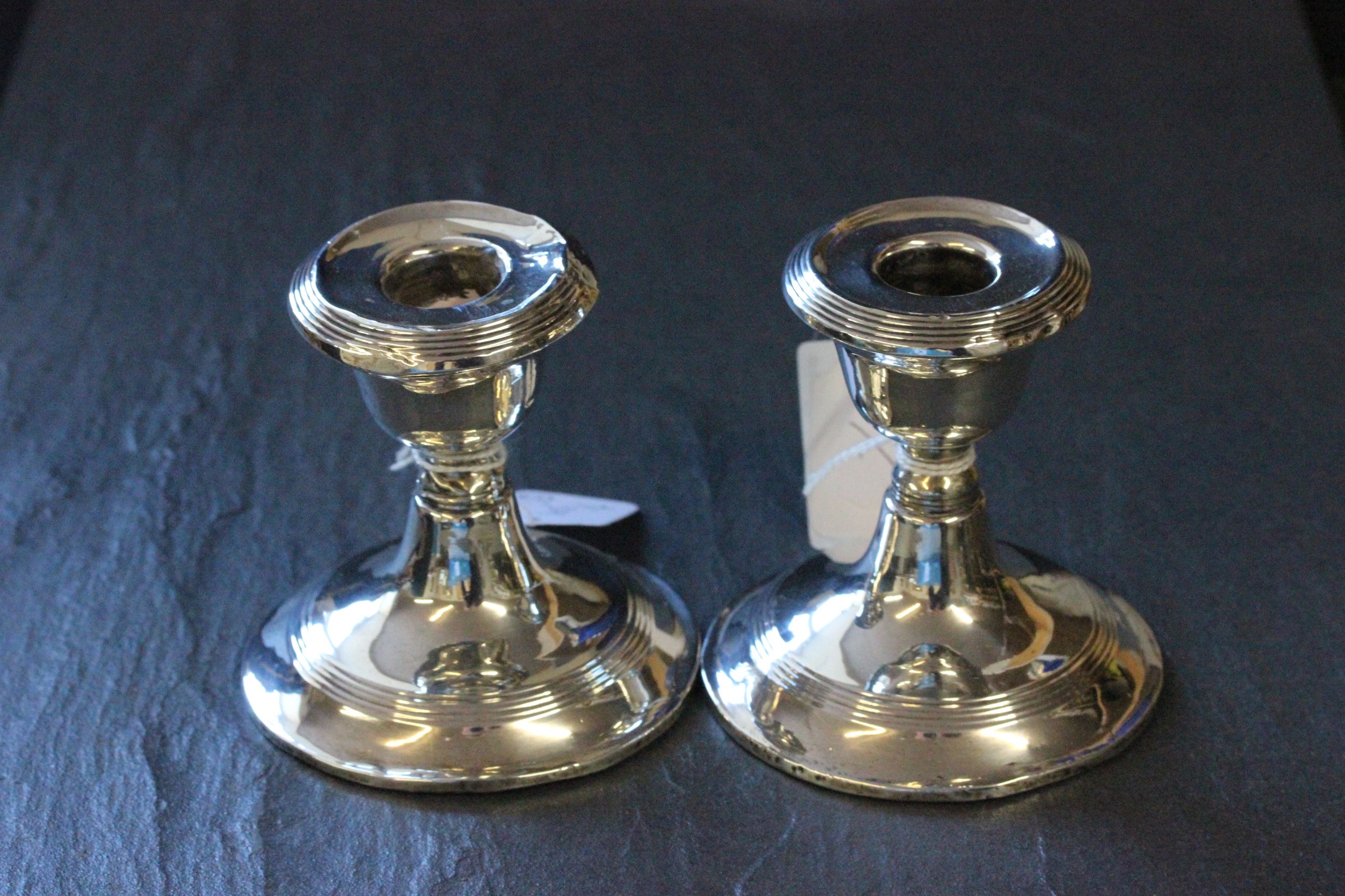 A pair of dwarf candlesticks, Birmingham 1911, weighted