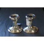 A pair of dwarf candlesticks, Birmingham 1911, weighted