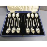 A cased set of 12 silver teaspoons and a pair of silver sugar nips, Birmingham 1939