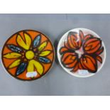 Two Poole Pottery pin dishes of Delphis design both with fire marks and one with crack to centre