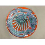 Poole Pottery plate shape 4 of abstract design with red ground, diameter 27cm