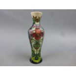 Moorcroft Pottery vase of slender baluster form designed by Philip Gibson with flowers and