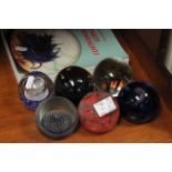 Six caithness glass paperweights plus a related book