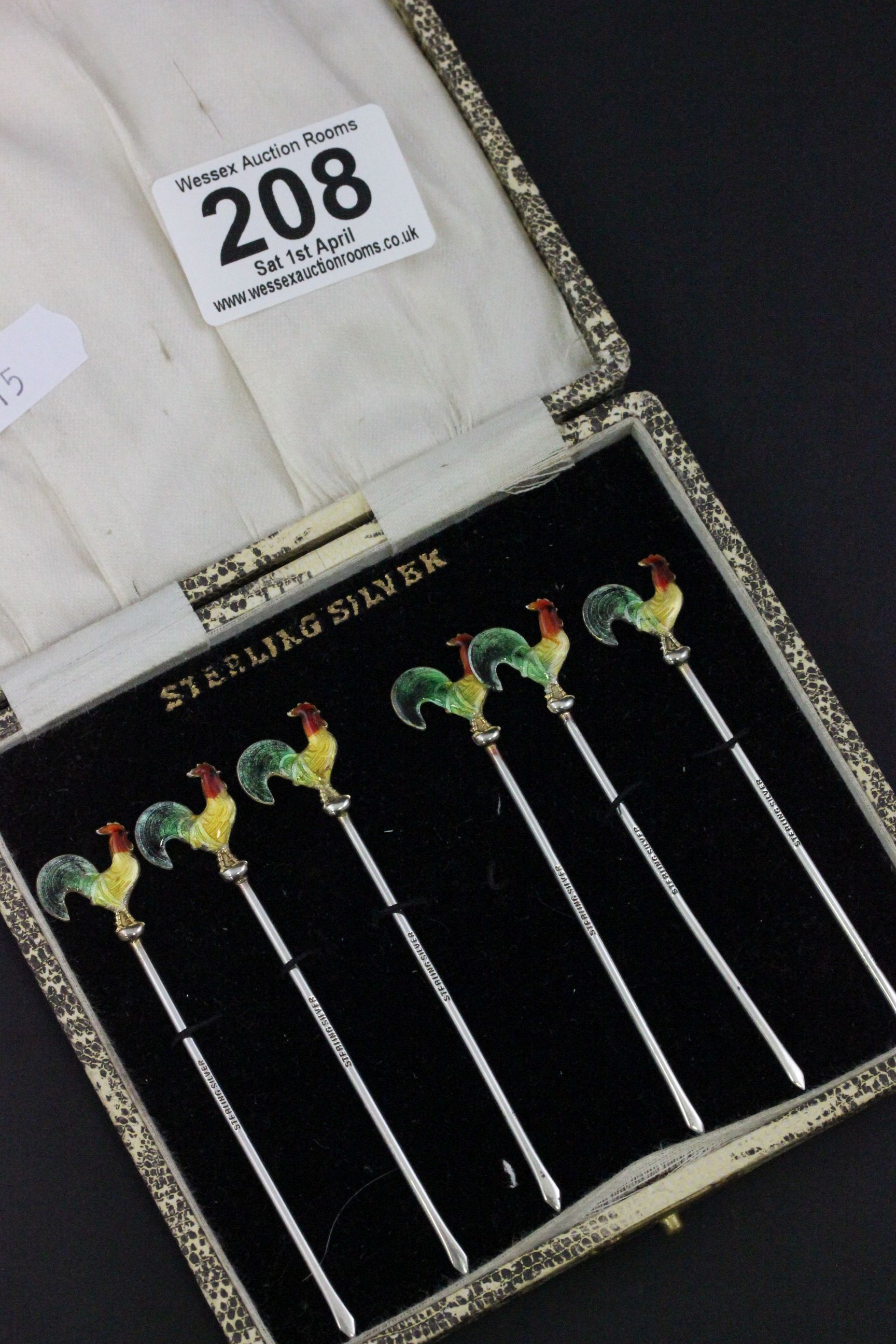 Cased Set of Six Sterling Silver Cocktail Sticks, each with an Enamel Cockerel Finial