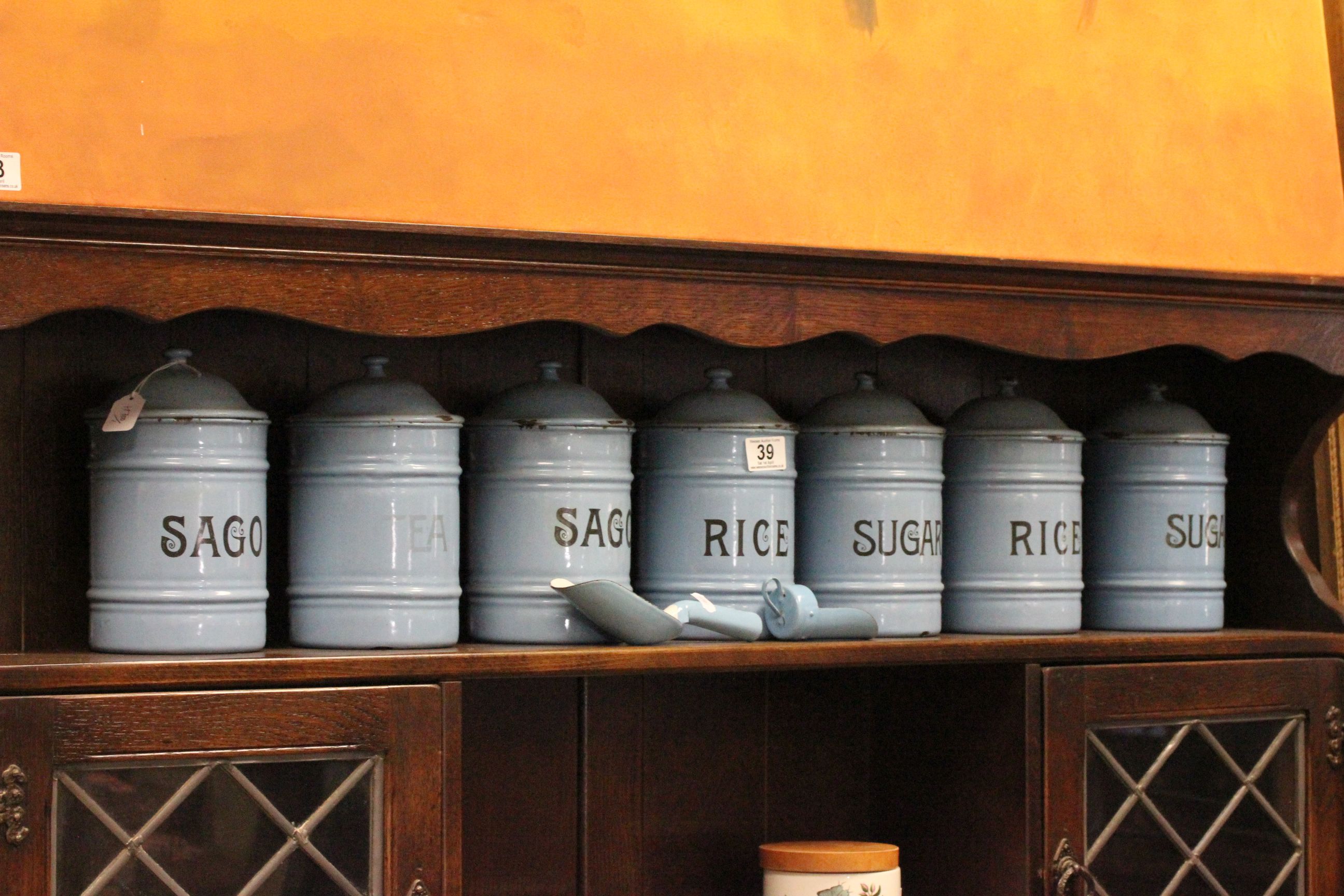 A set of 7 vintage blue enamel kitchen containers, along with two matching shovels