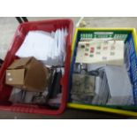 Two plastic containers with quantity of world stamps in white envelopes, small carton mostly used