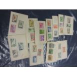 Quantity of mint stamps hinged on paper sets of the world