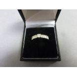 18ct White Gold Diamond Ring with central brilliant cut stone and baguette shoulders, 1ct