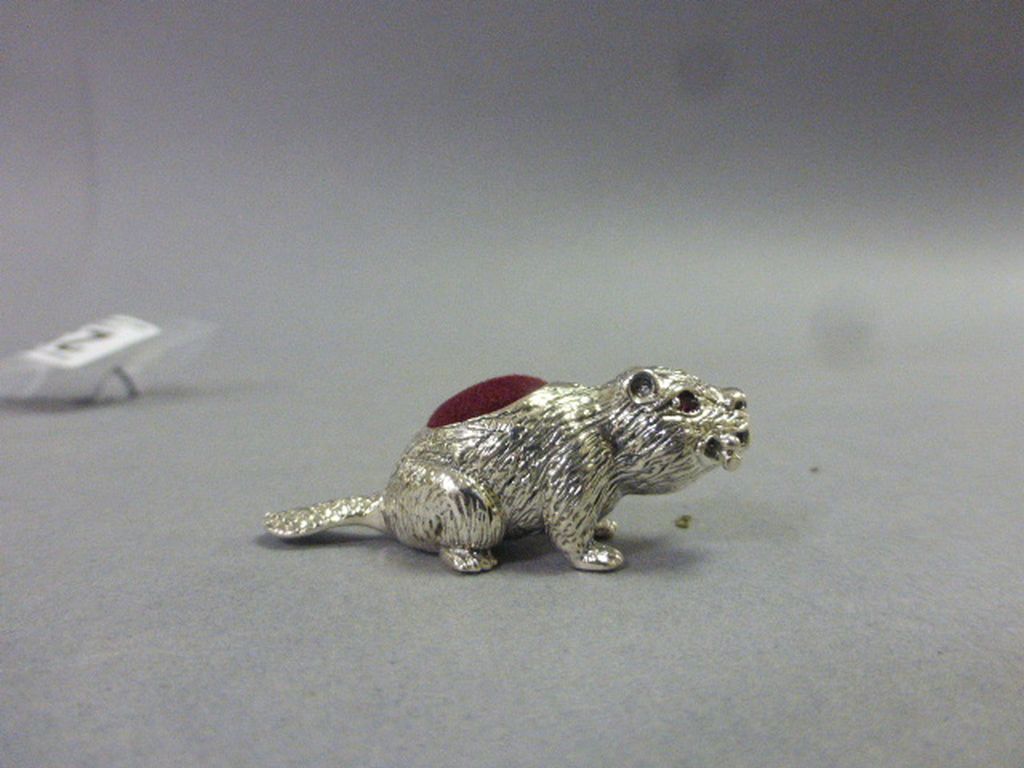 Silver Pin Cushion of a Dog carrying a bone with ruby eyes