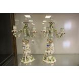 A pair continental ceramic two section candelabra with a seated lady holding a boy