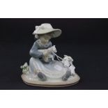 A Lladro figure of a girl holding a lamb