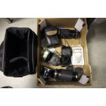 A collection of cameras and lenses including Olympus