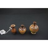 Three miniature stoneware jugs, two marked "Royal Doulton"